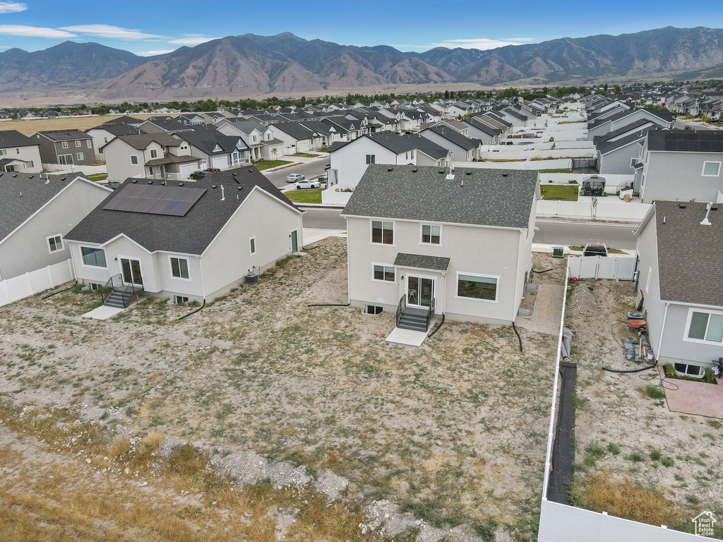 Aerial view of residential area featuring a mountainous background