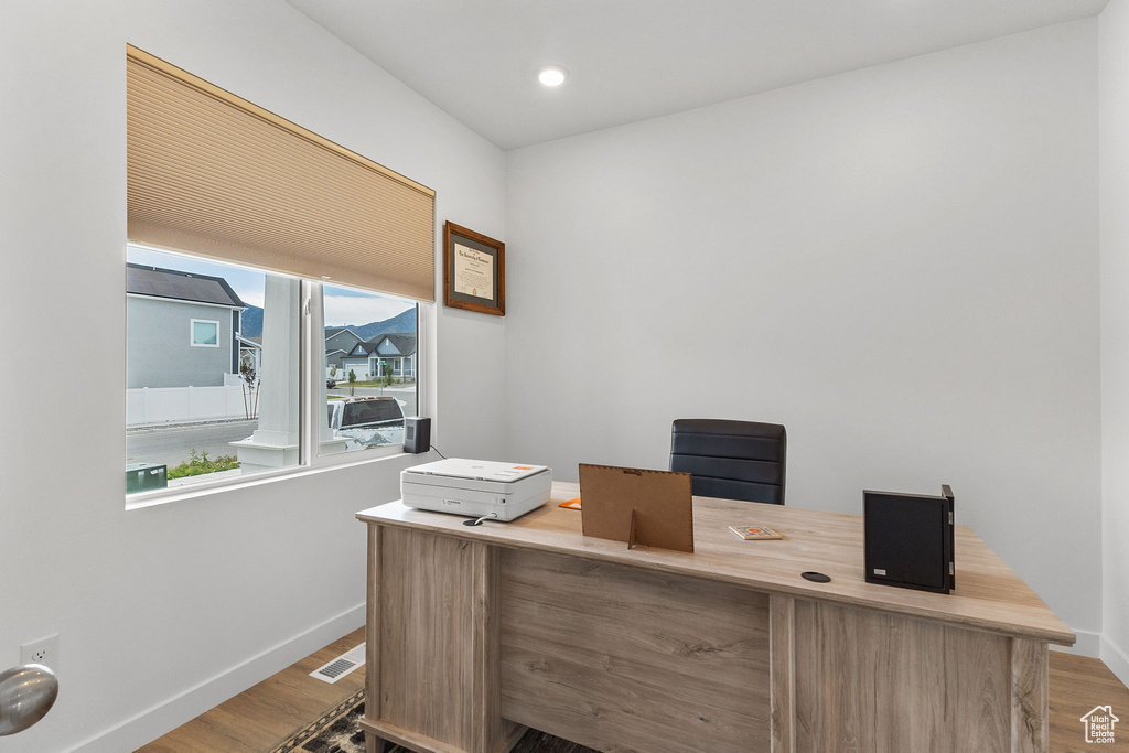 Home office featuring wood finished floors and recessed lighting