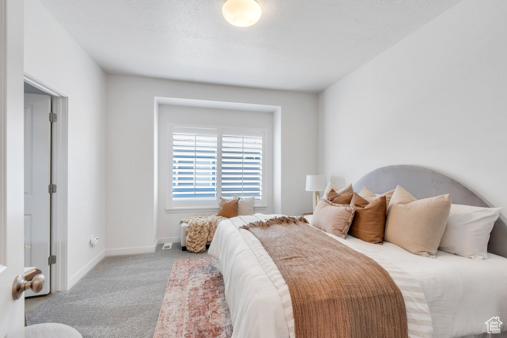 Bedroom featuring carpet flooring and baseboards