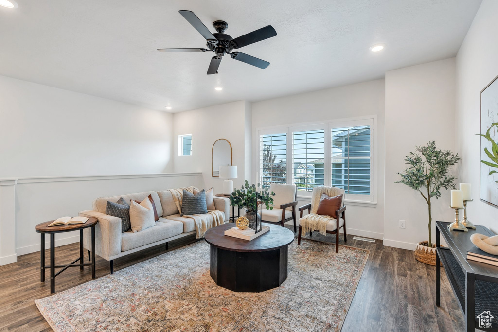 Living area featuring wood finished floors, ceiling fan, and recessed lighting