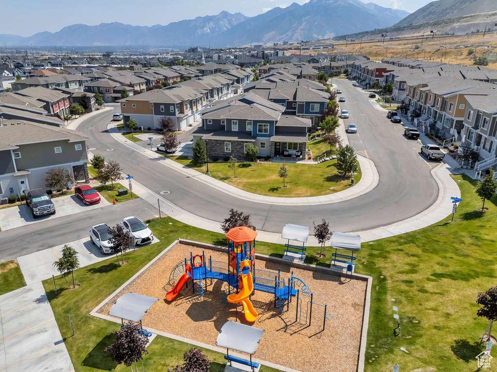 Aerial perspective of suburban area with a mountain backdrop and a recreational park
