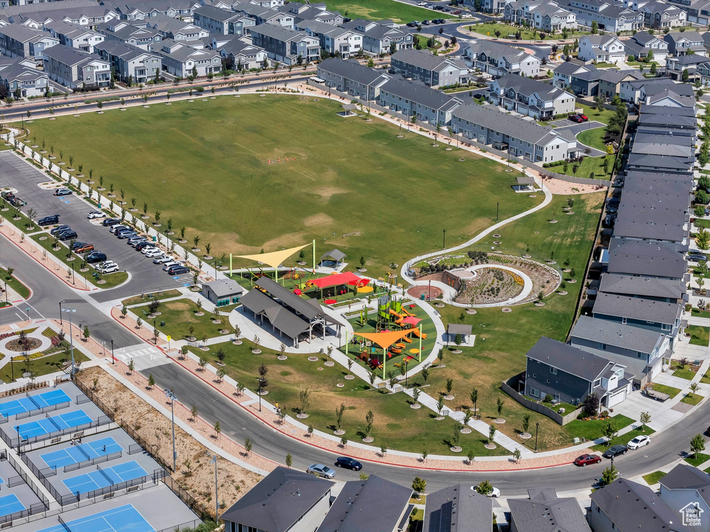Aerial view of property and surrounding area featuring nearby suburban area