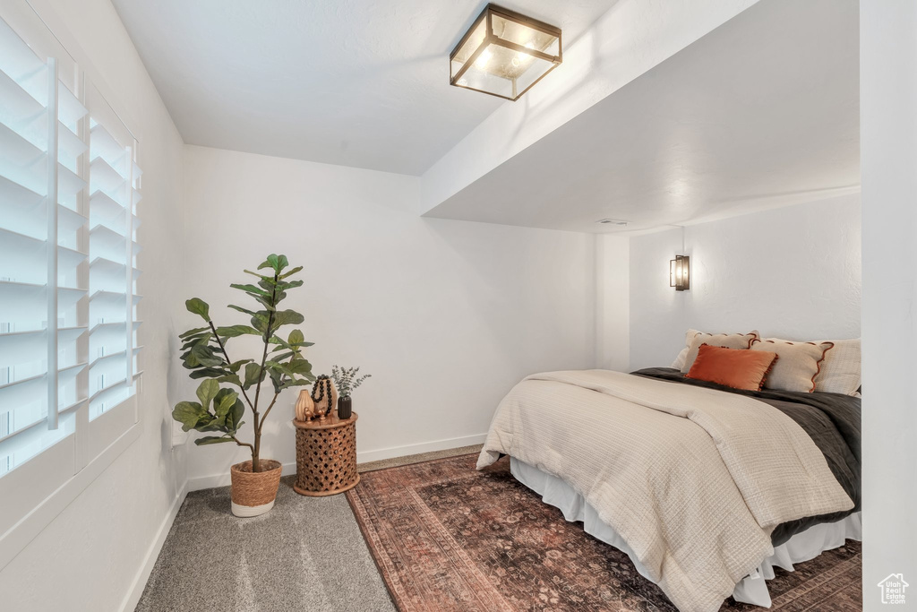 Bedroom with baseboards and carpet flooring