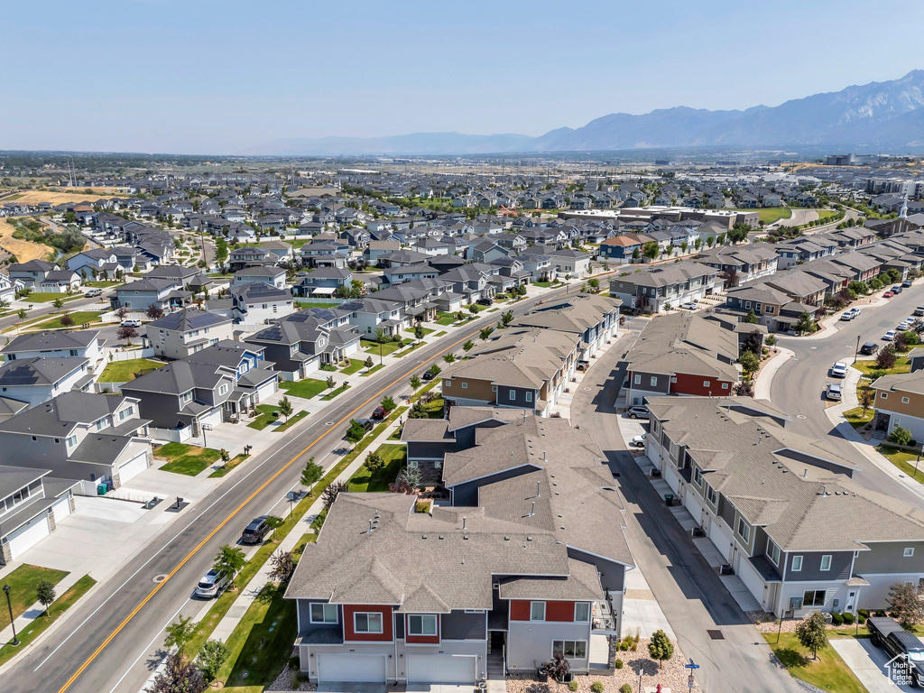 Aerial view of property's location featuring a mountainous background and nearby suburban area