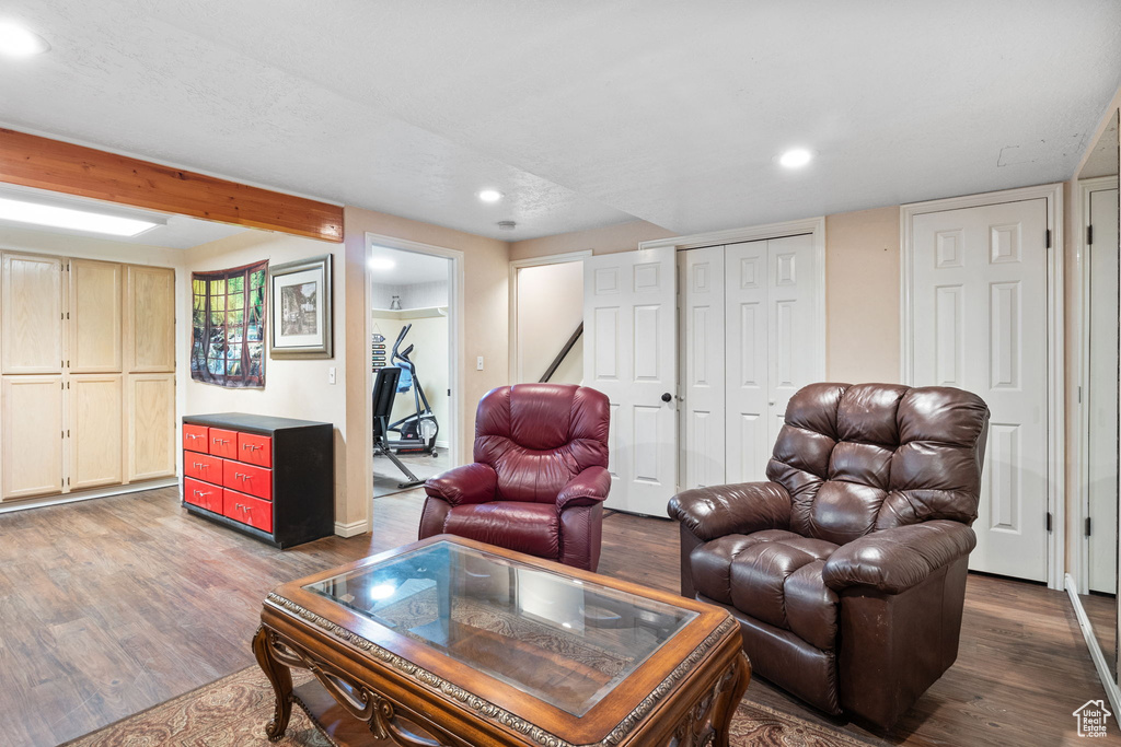Living area featuring wood finished floors, recessed lighting, and beamed ceiling