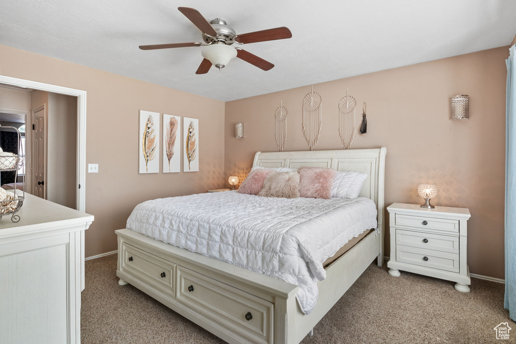 Bedroom with light colored carpet and ceiling fan