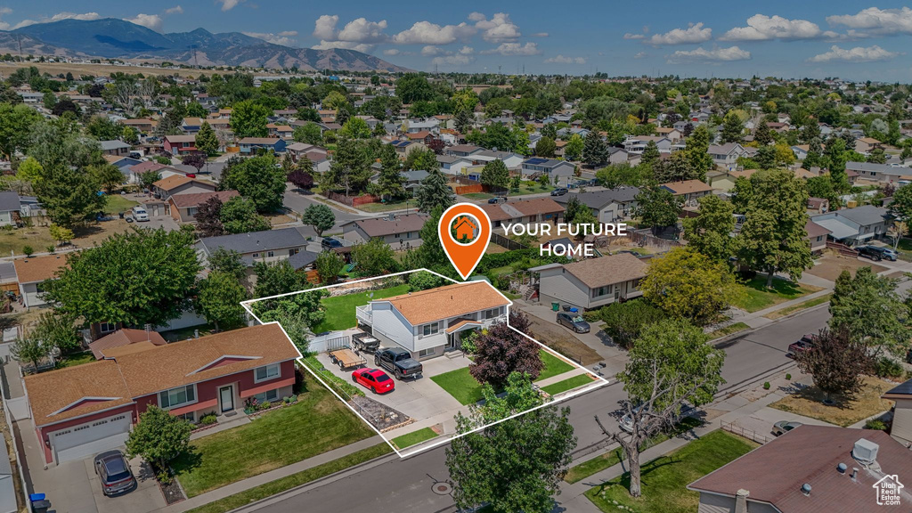 Aerial view of residential area featuring property parcel outlined and a mountainous background
