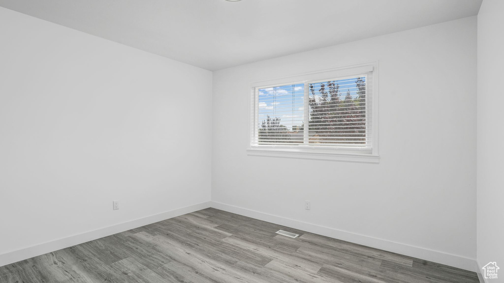 Spare room featuring wood finished floors