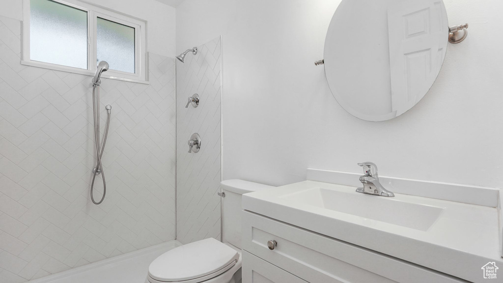 Bathroom featuring vanity and a tile shower