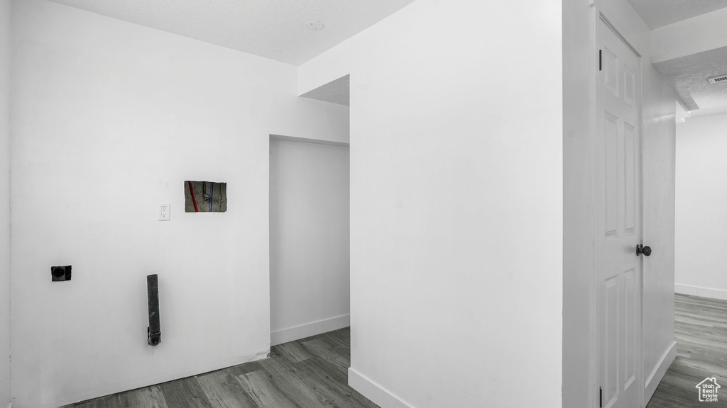Washroom featuring hookup for an electric dryer, wood finished floors, and hookup for a washing machine