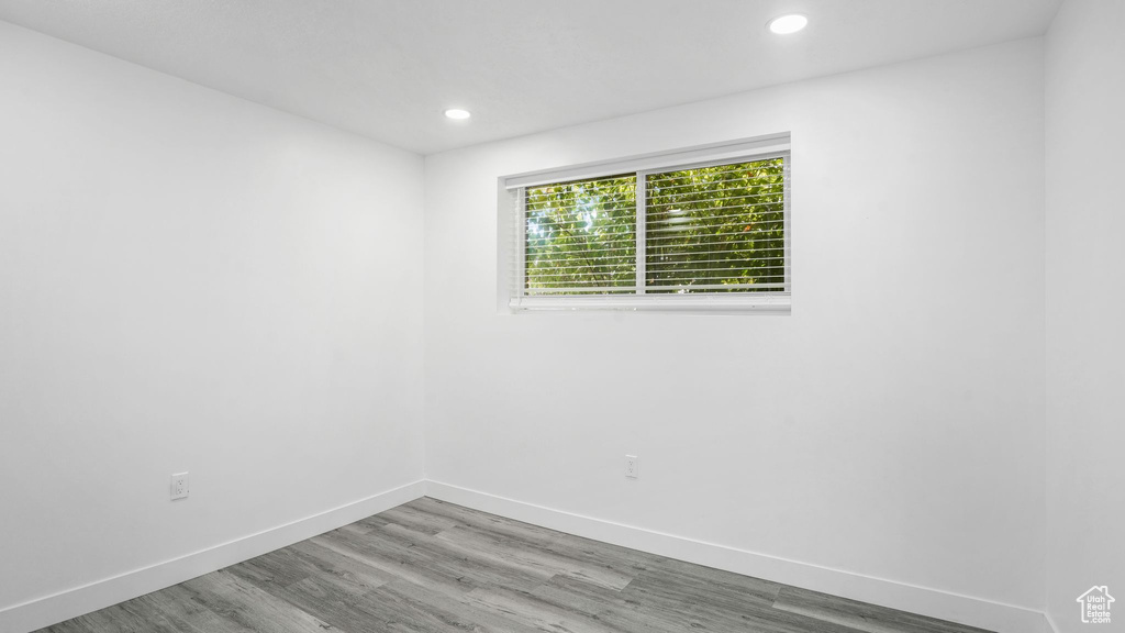 Empty room with wood finished floors and recessed lighting