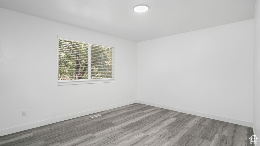 Spare room featuring wood finished floors and baseboards