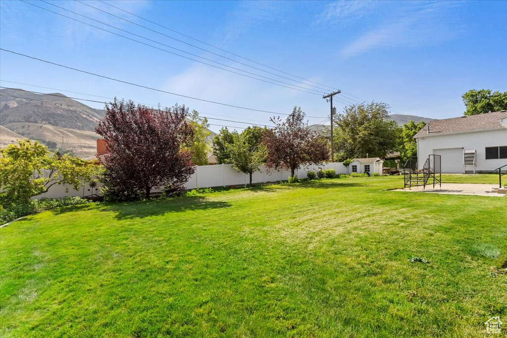 View of yard with a mountain view and a patio area