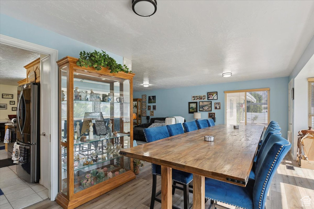 Dining room featuring a textured ceiling and light wood-style floors