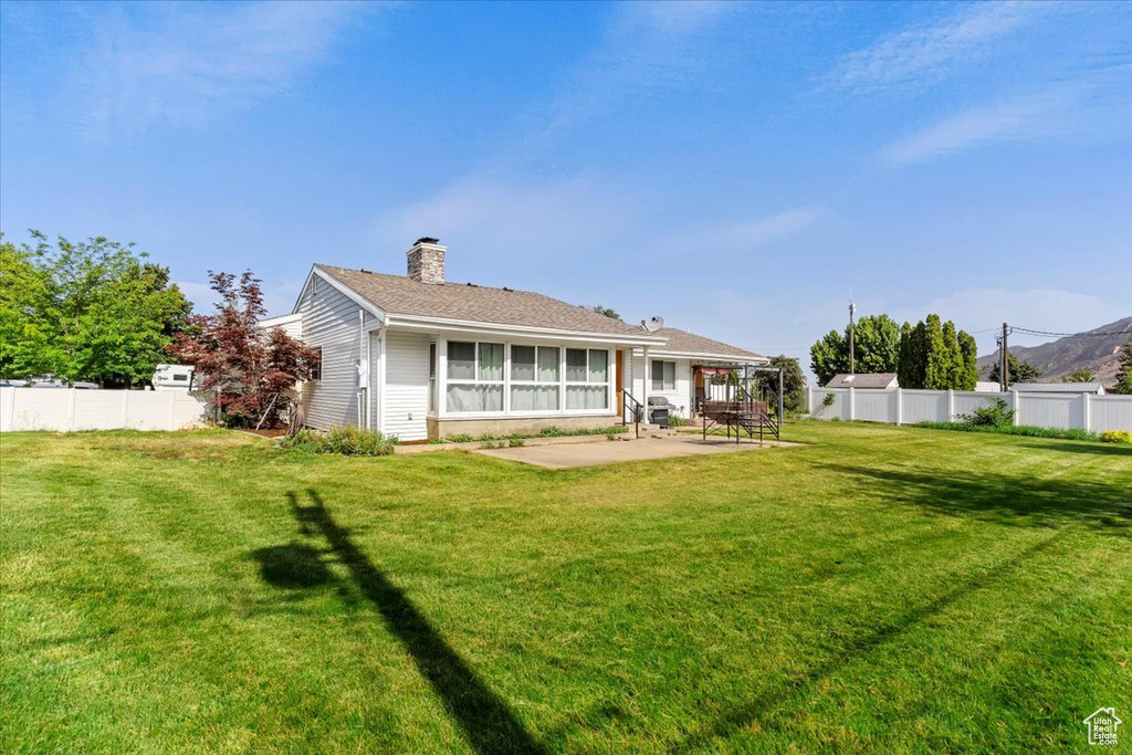 Back of property with a patio area and a chimney