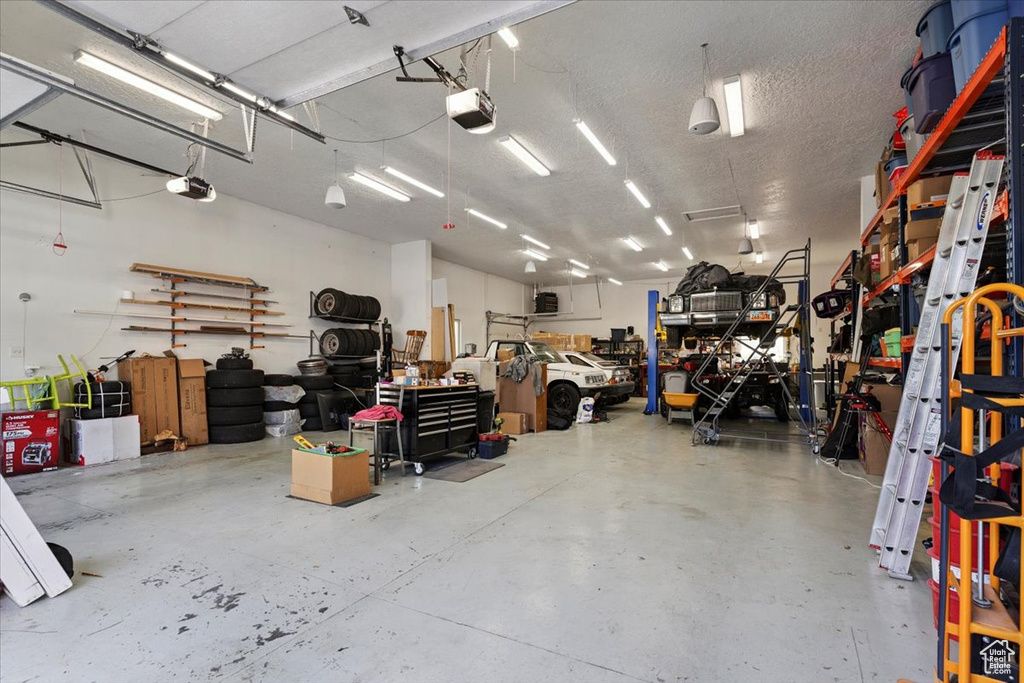 Garage featuring a workshop area and a garage door opener