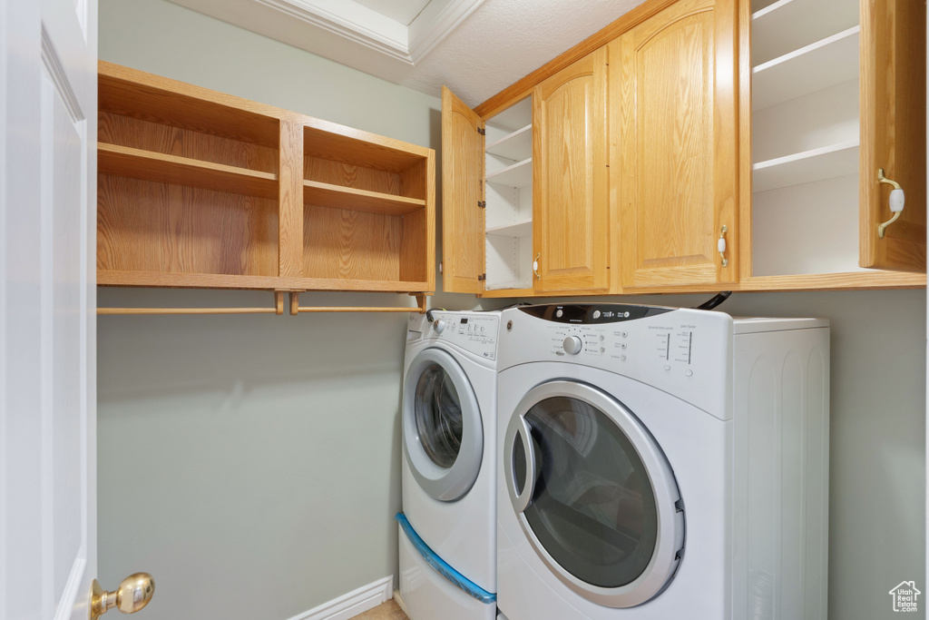 Laundry room featuring washing machine and dryer and cabinet space