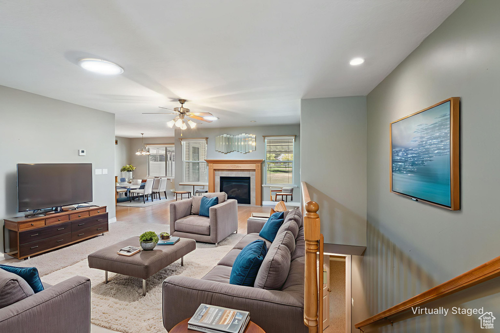 Carpeted living room with a ceiling fan