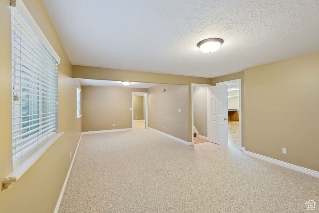 Spare room with baseboards and a textured ceiling