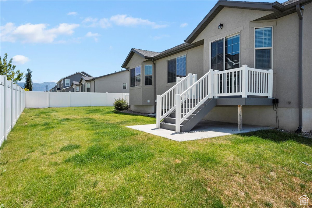 Fenced backyard with a patio area