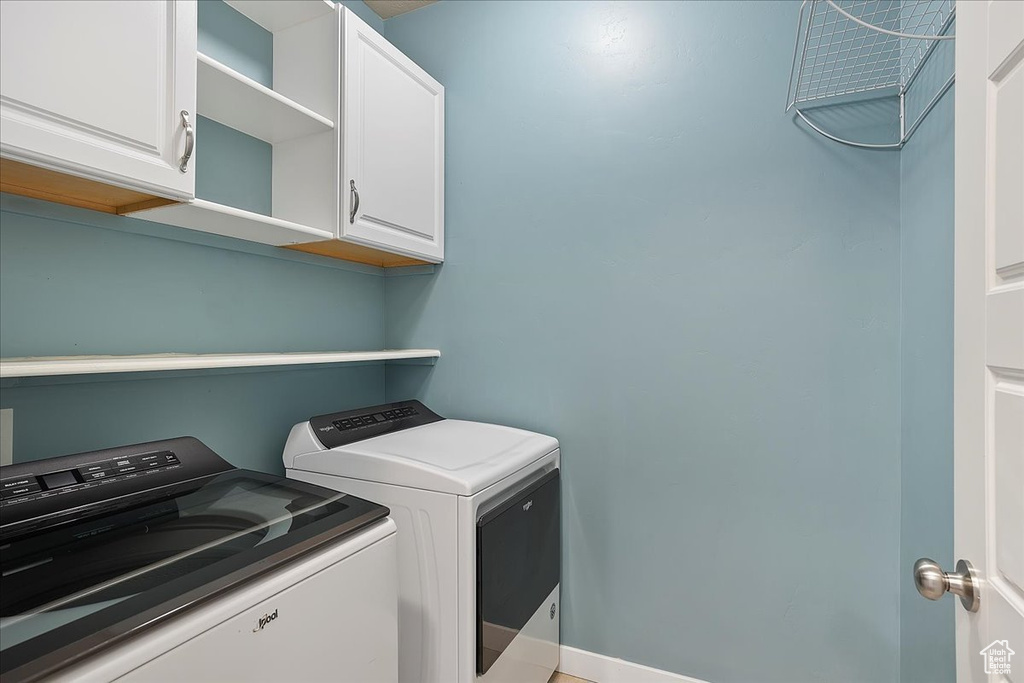 Washroom with washing machine and dryer and cabinet space