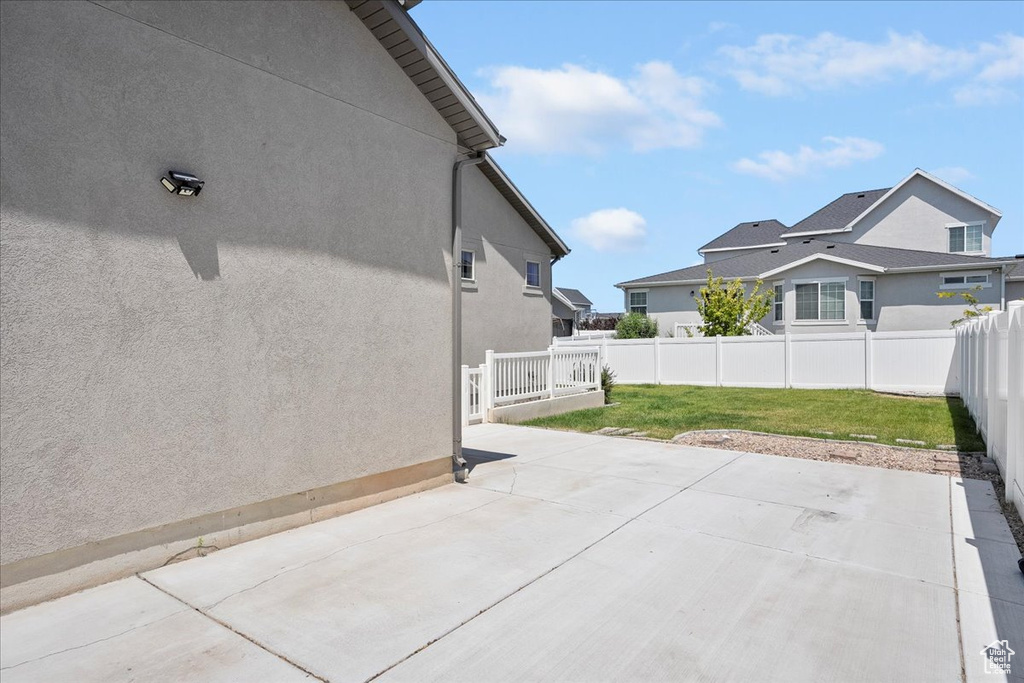 Fenced backyard with a patio