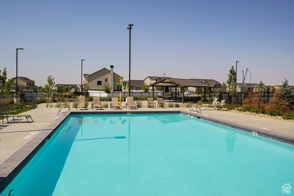 Community pool featuring a residential view and a patio