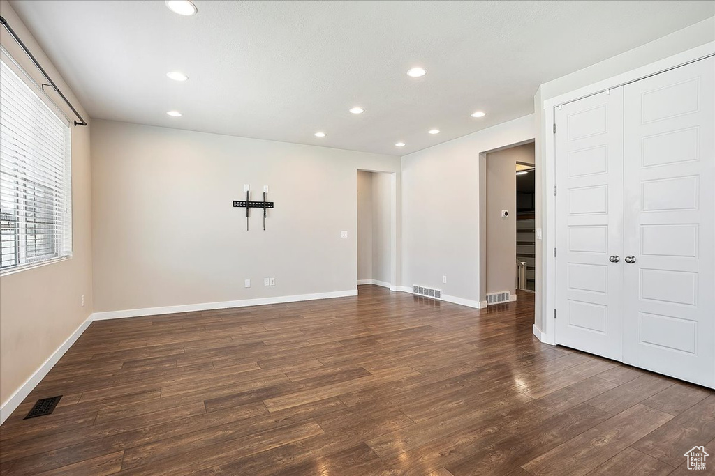 Spare room with wood finished floors and recessed lighting