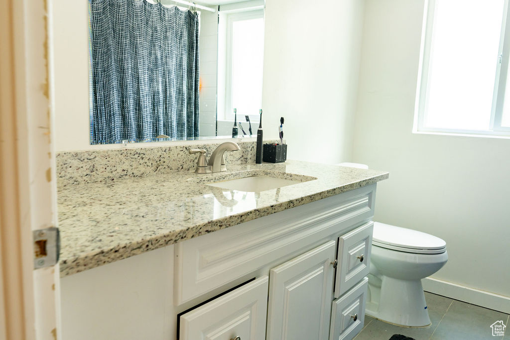 Full bathroom with vanity, tile patterned flooring, and a shower with curtain