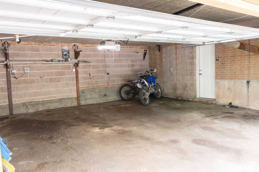 Garage featuring concrete block wall