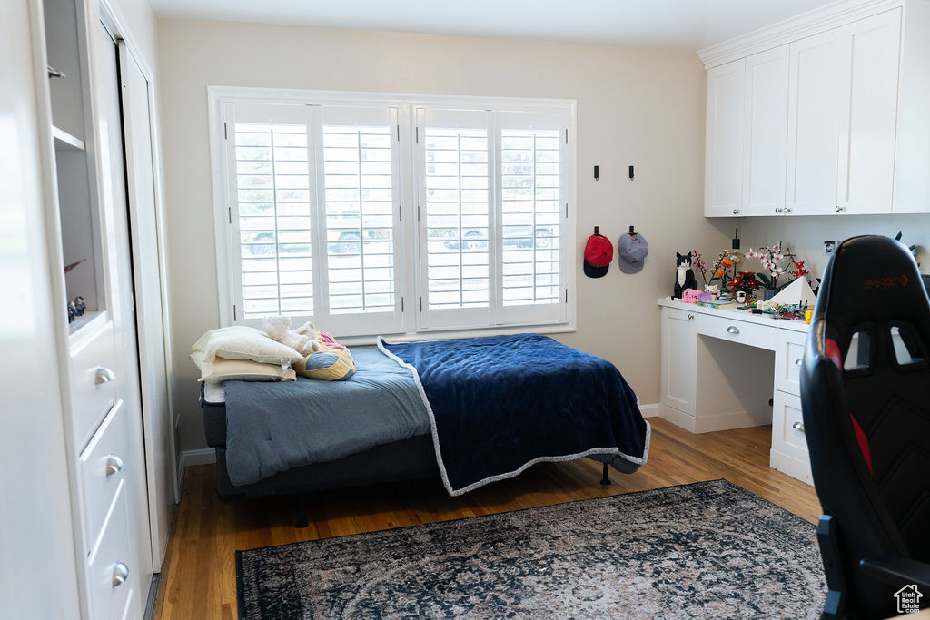 Bedroom featuring light wood finished floors and baseboards