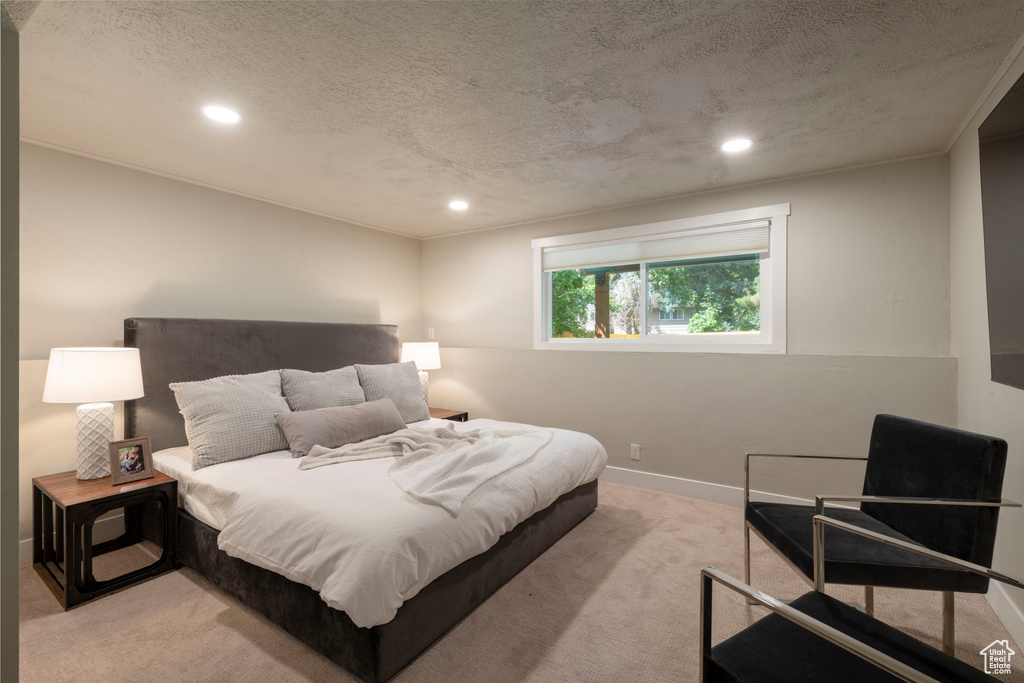 Bedroom featuring light carpet, recessed lighting, and a textured ceiling