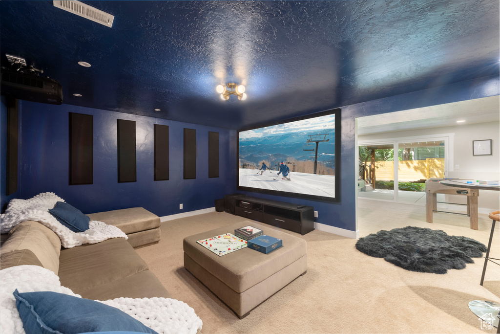 Home theater room featuring carpet and baseboards
