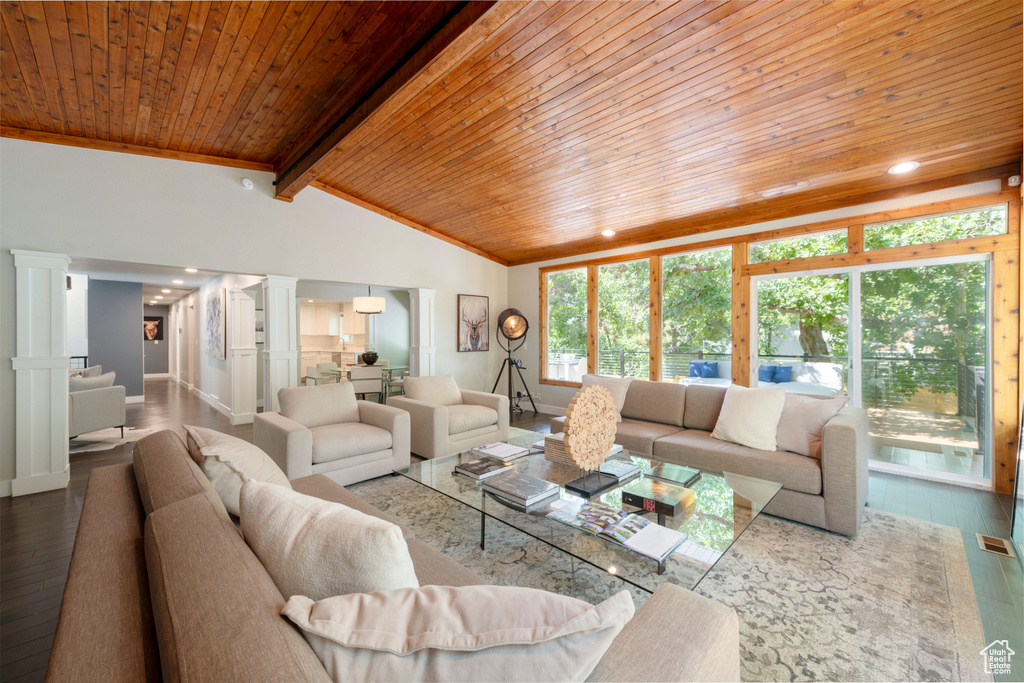 Living room featuring wood ceiling, decorative columns, wood finished floors, and recessed lighting