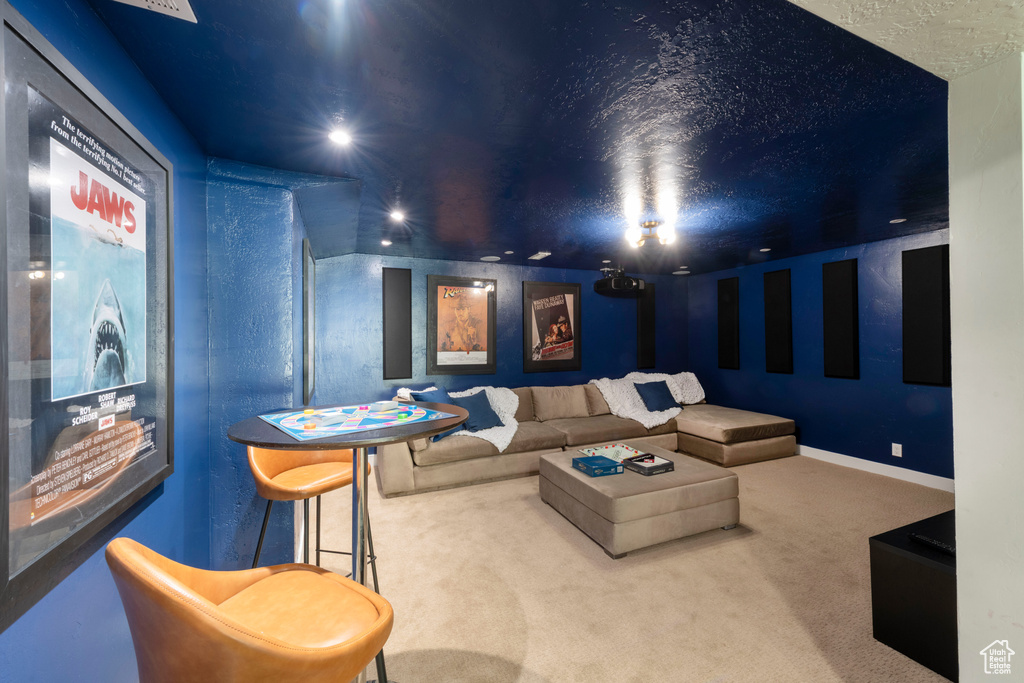 Carpeted home theater room featuring baseboards and recessed lighting