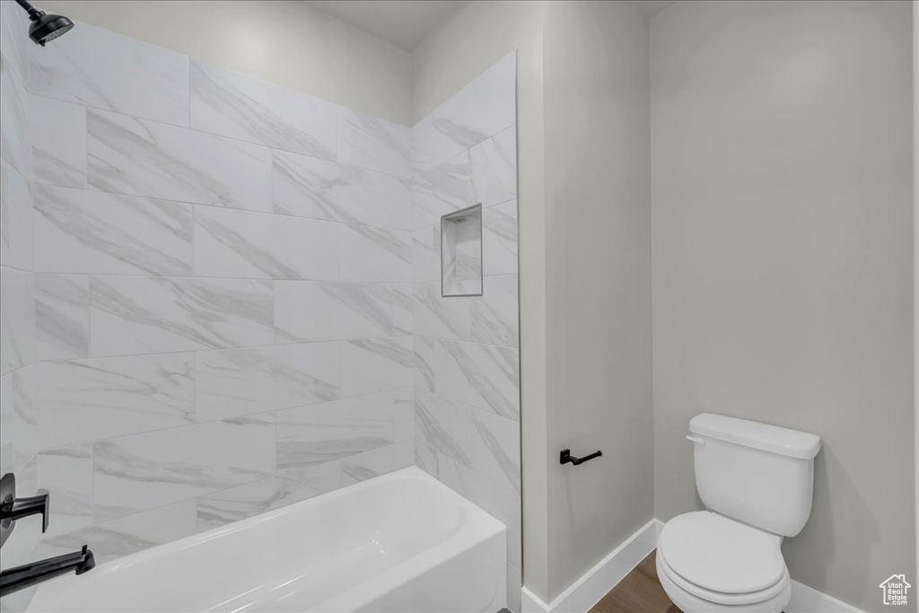 Full bathroom featuring baseboards and shower / tub combination