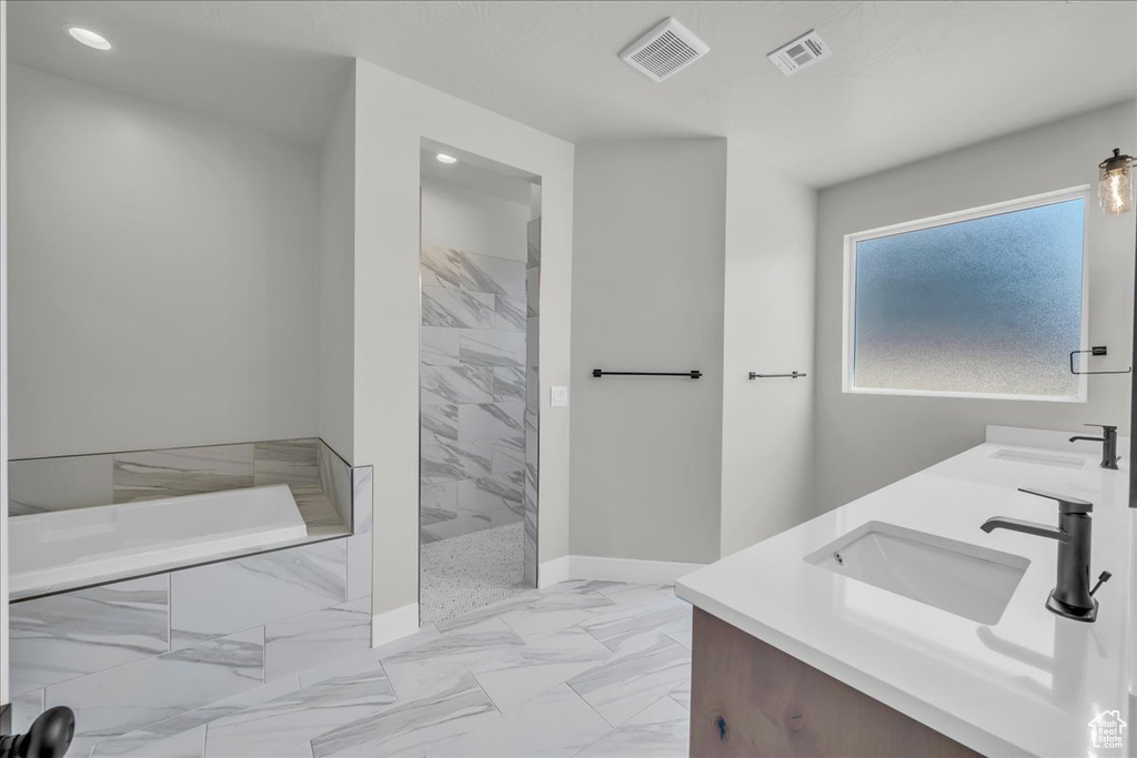 Bathroom with double vanity, a garden tub, tiled shower, marble finish flooring, and recessed lighting