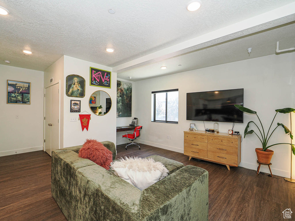 Living room with wood finished floors, recessed lighting, and a textured ceiling