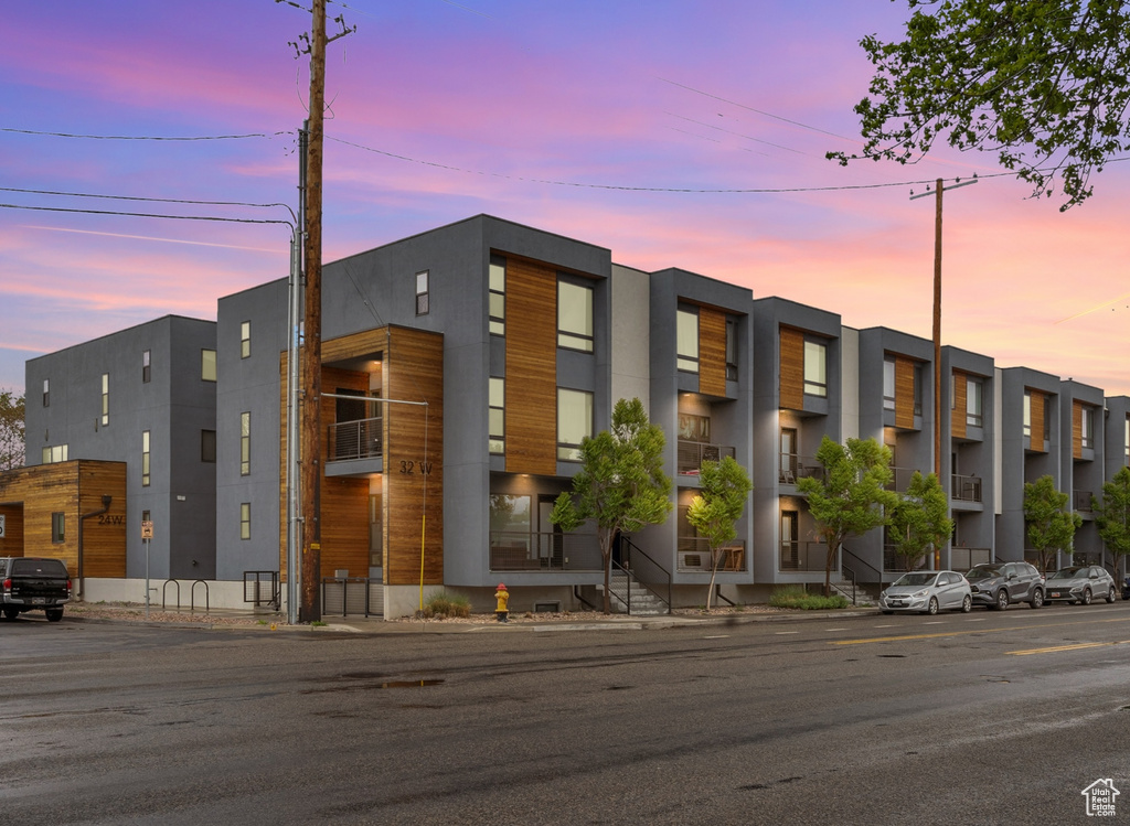 View of property at dusk