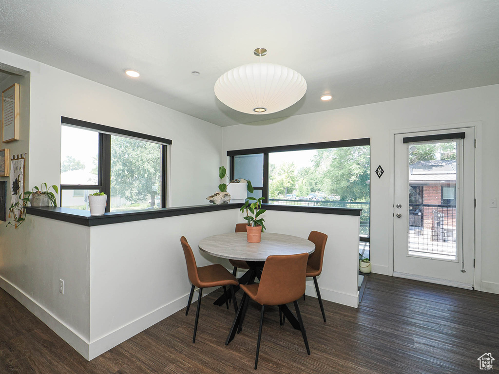 Dining area with wood finished floors and recessed lighting
