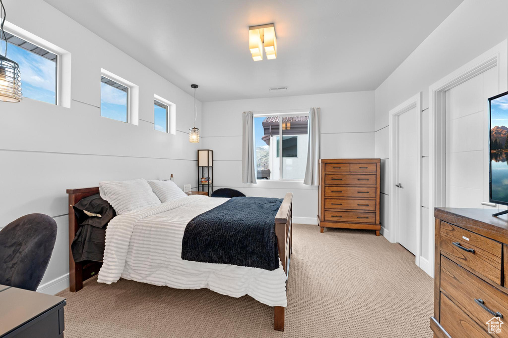 Bedroom with light colored carpet