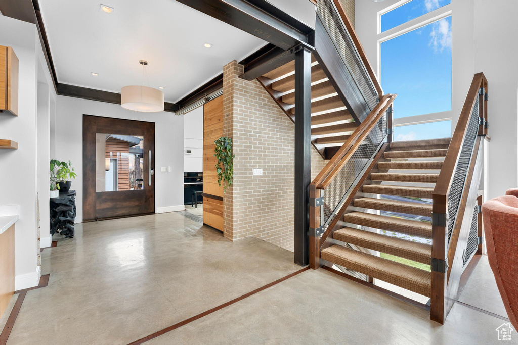 Stairway featuring concrete floors and recessed lighting