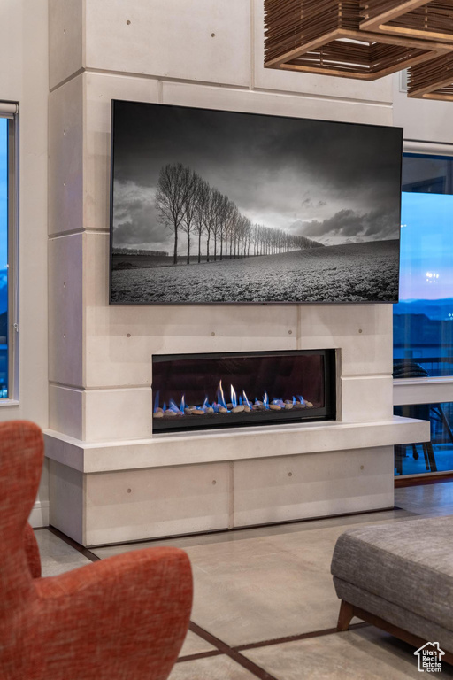 Detailed view of a glass covered fireplace and concrete flooring