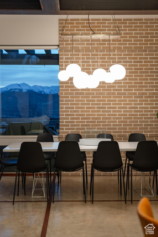 Dining area featuring concrete flooring and brick wall