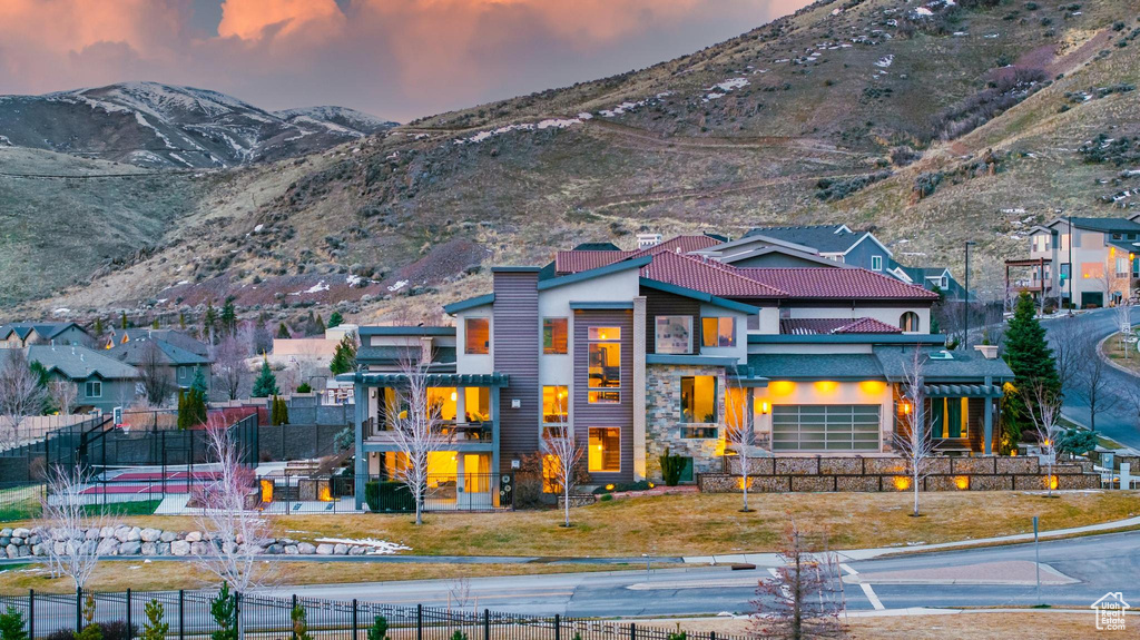 Exterior space with a mountain view, stone siding, and stucco siding