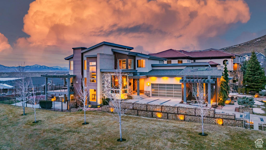 Back of house with a pergola, a patio, and a mountain view