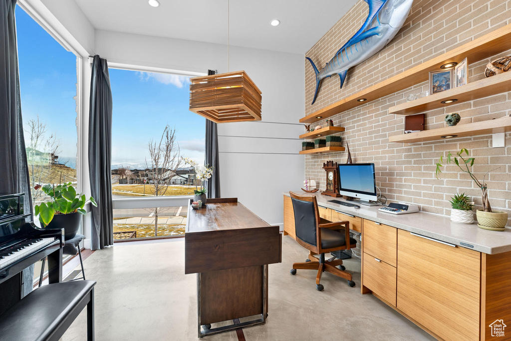 Office area featuring finished concrete flooring, plenty of natural light, and recessed lighting