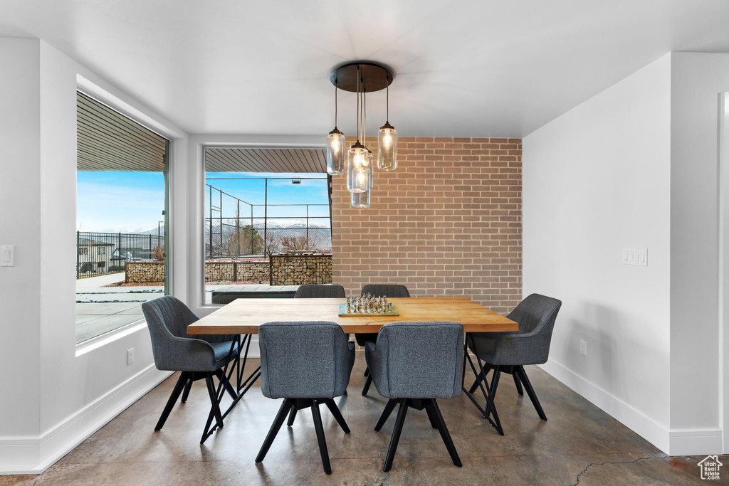 Dining area featuring concrete flooring and brick wall