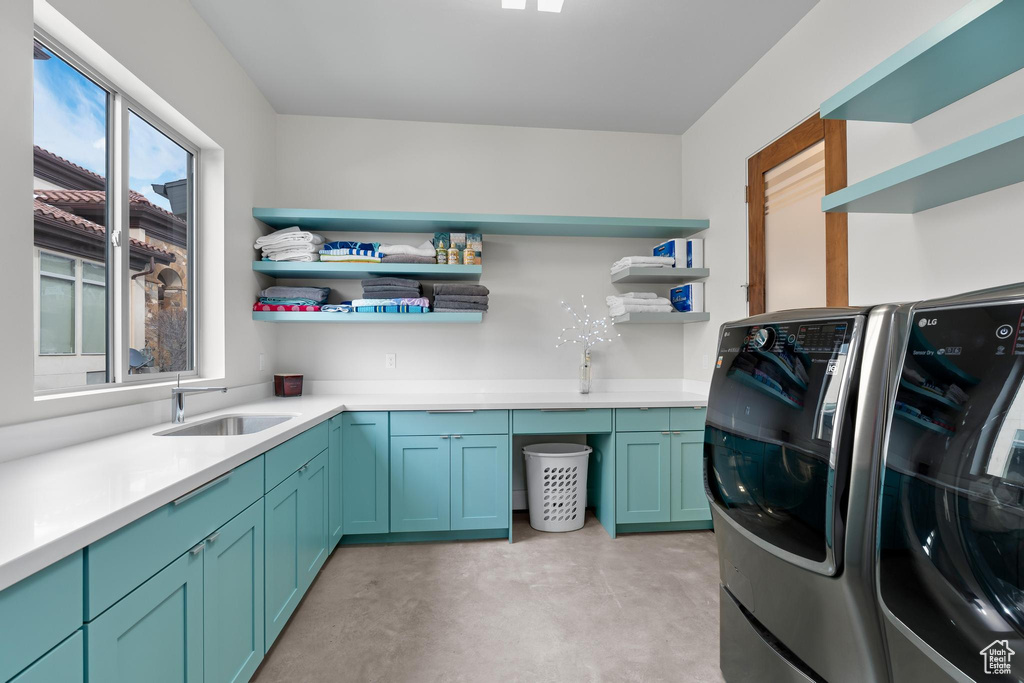 Laundry room with washer and clothes dryer and cabinet space