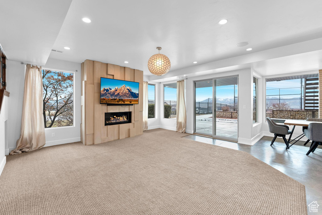 Living room featuring recessed lighting and a warm lit fireplace
